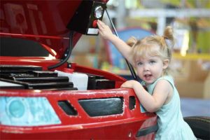 little girl repairing car